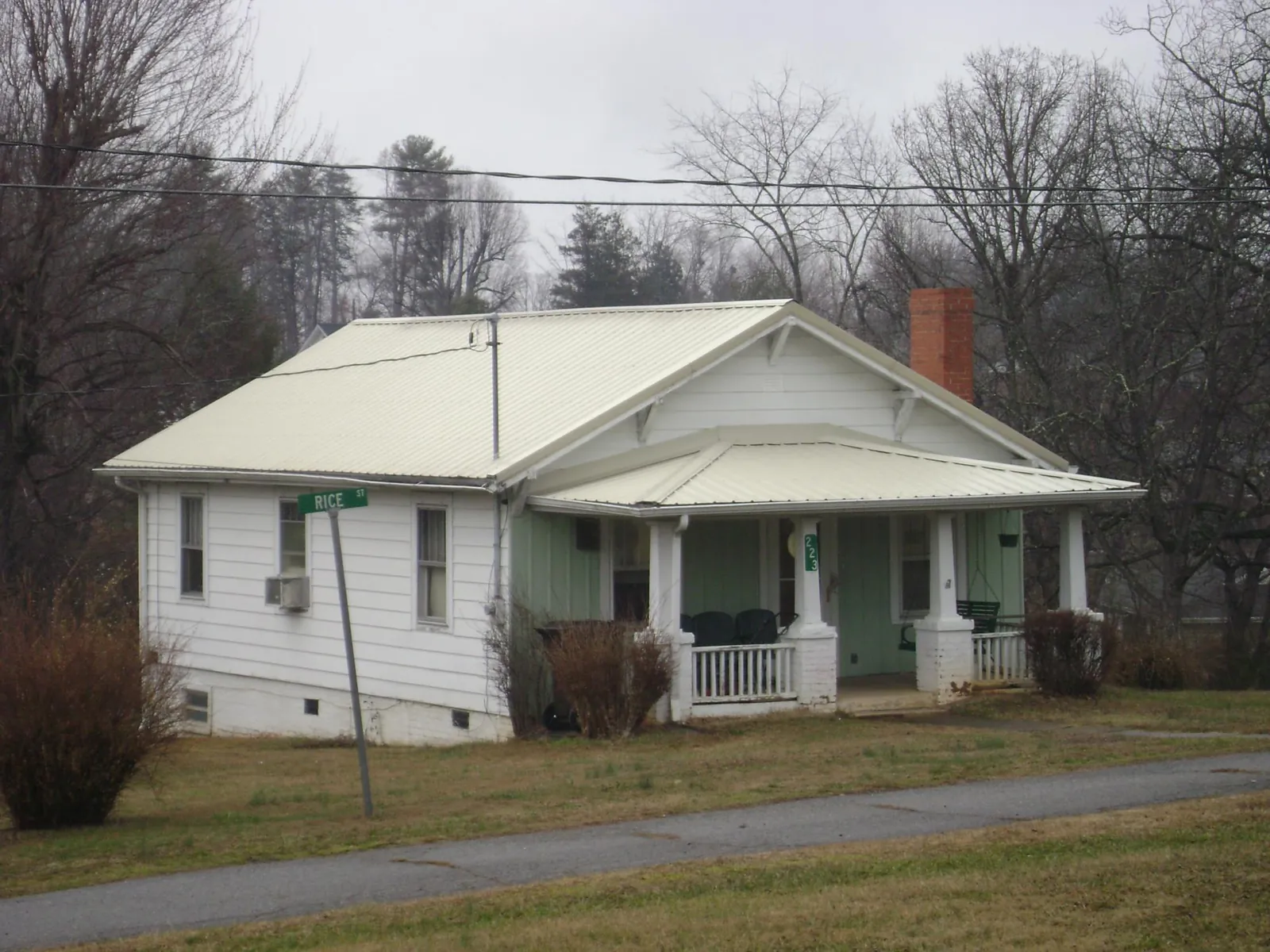 White metal roof on a craftsman bungalow at a street corner in Ava